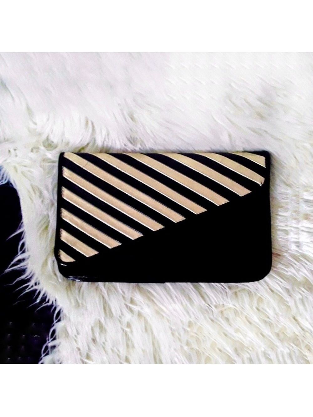 black and gold striped diagonal flap clutch